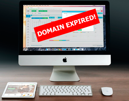 A monitor displaying a red DOMAIN EXPIRED warning banner over a dashboard screen